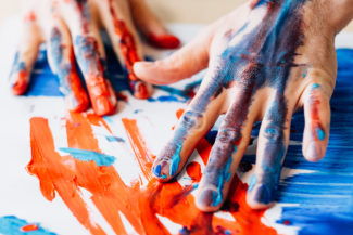 Art therapy.hands in red blue paint.  Artist talent creative style technique.